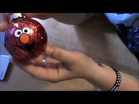 Applying vinyl to a round surface layered Elmo sesame Street ornament for christmas